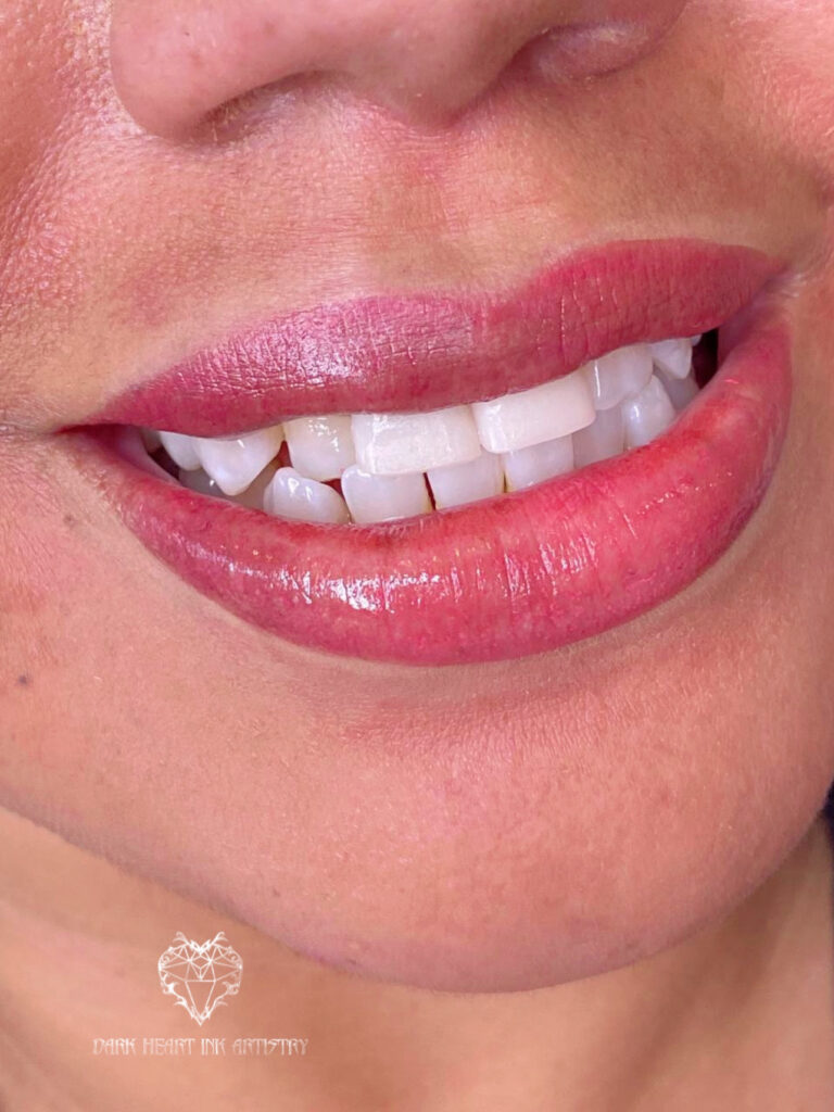 A close up of a woman's mouth with white teeth at home.