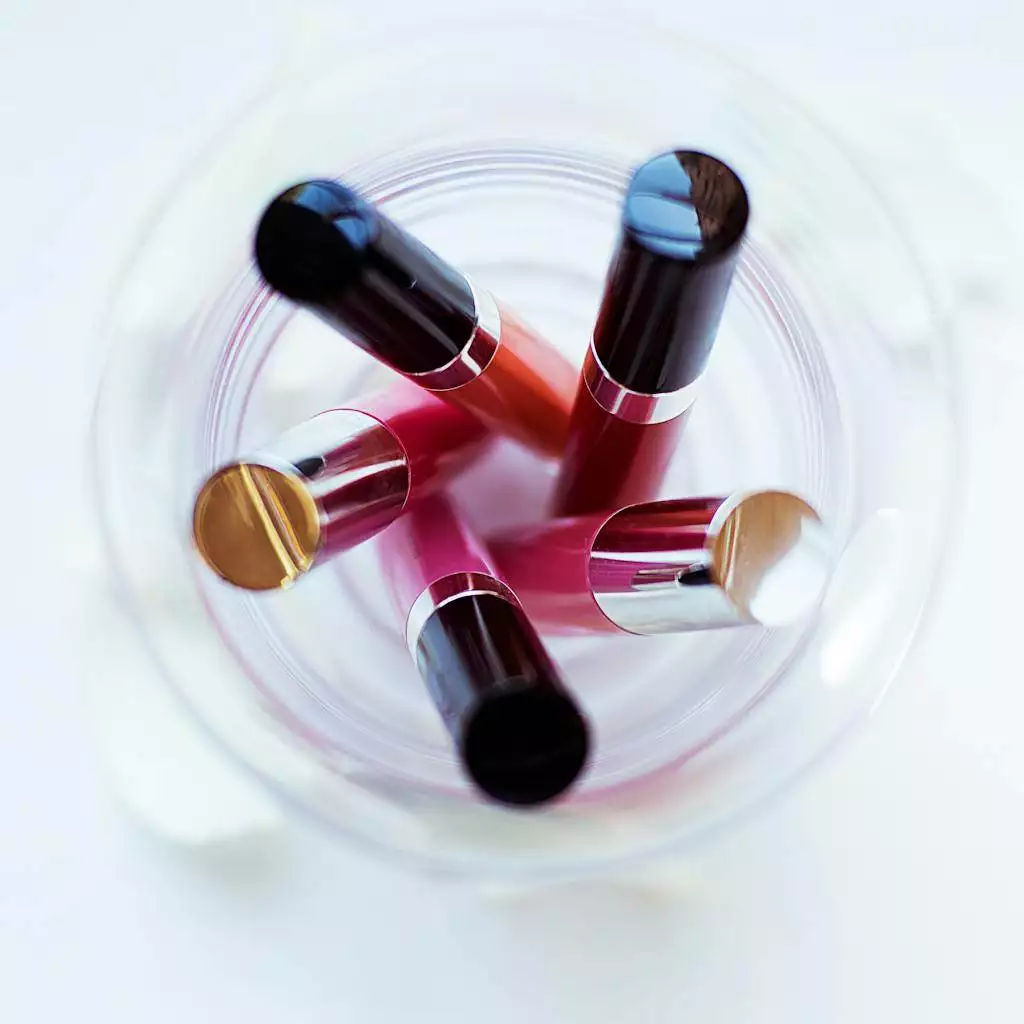 Five Assorted-color Liquid Lipsticks Placed on Glass